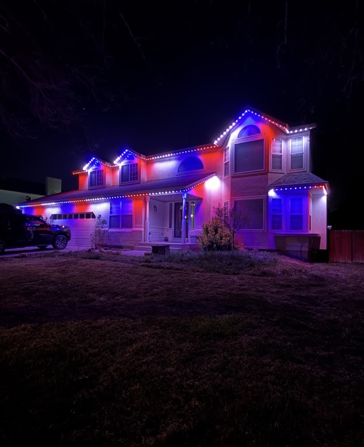 Home lit with red, white, and blue permanent LED colors